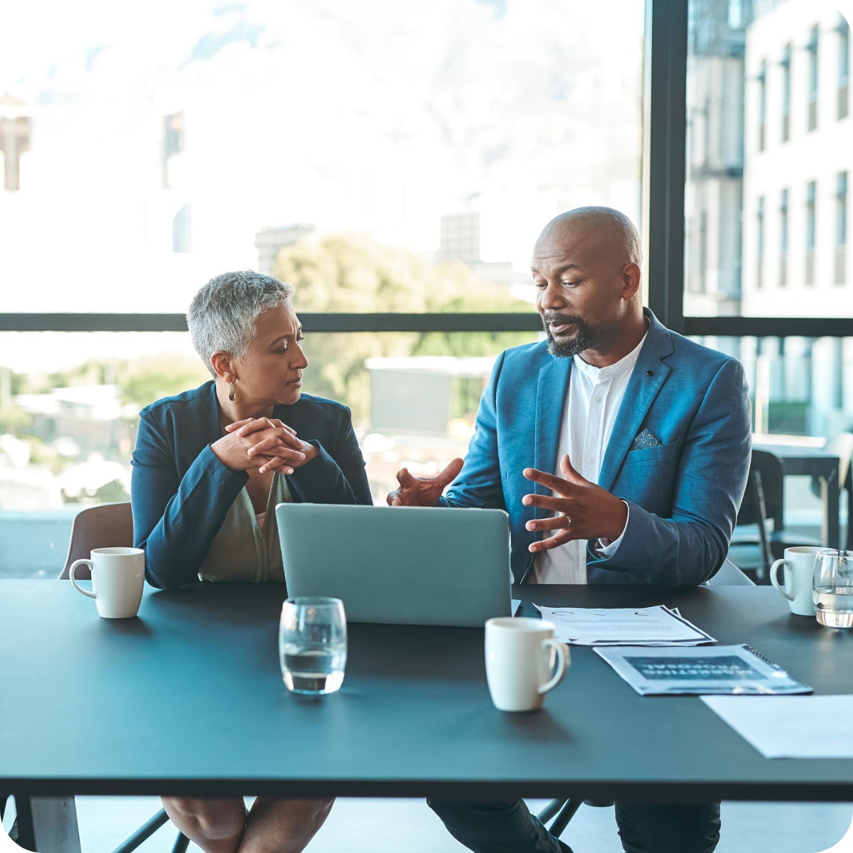 image showing two people talking in an office about tax credit opportunities